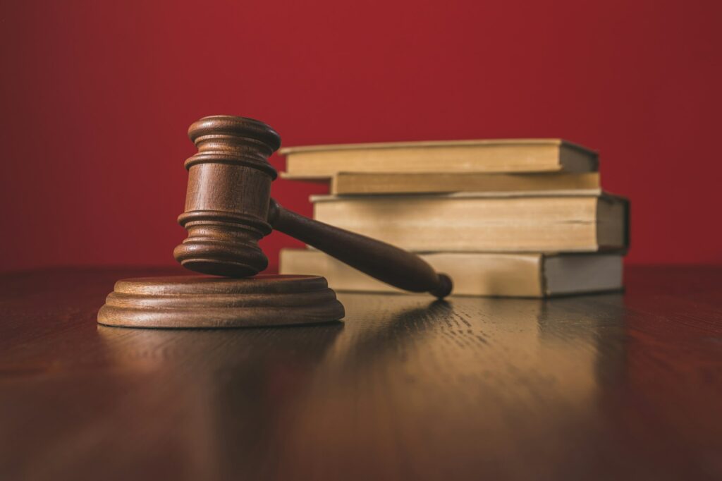 juridical books with hammer on wooden table, law concept