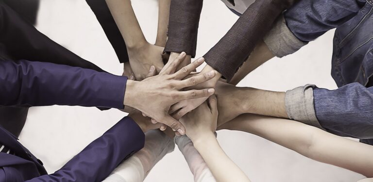 Multicultural hands synergy brainstorm business man woman in circle top view background