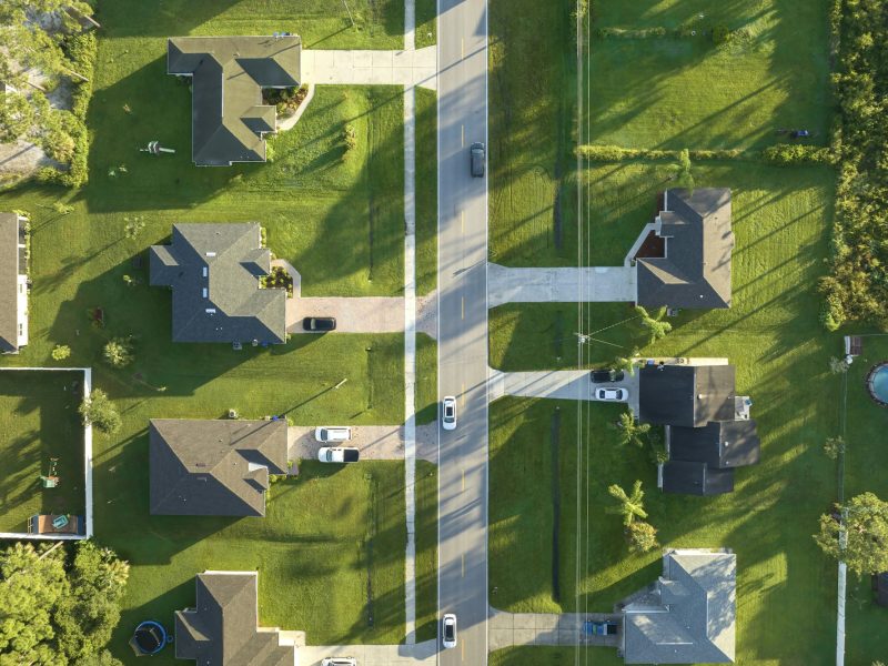 Aerial view of american small town in Florida with private homes between green palm trees